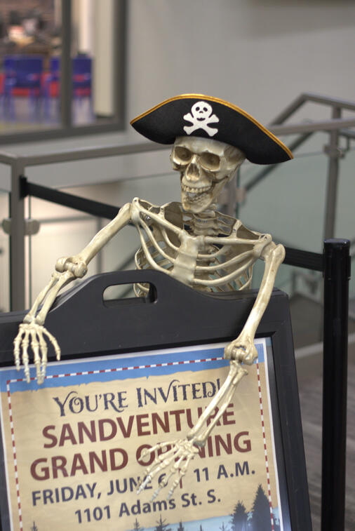 A decorative skeleton holds signage during the sale day to promote the grand opening